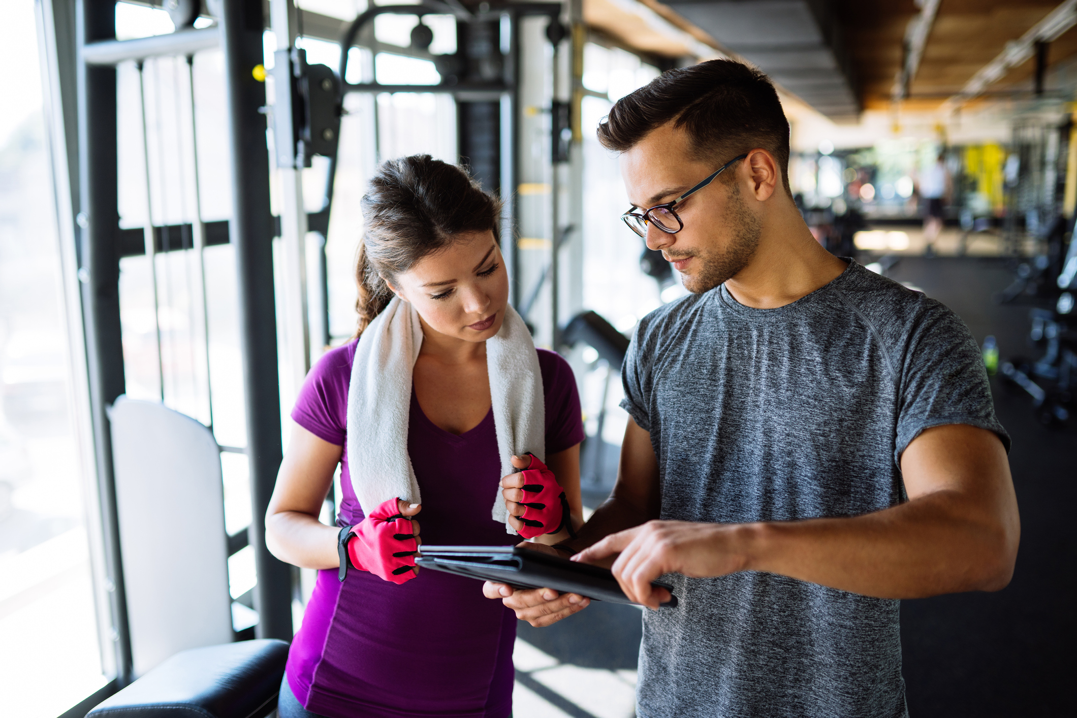 Personal trainer meeting with a member for a fitness consultation