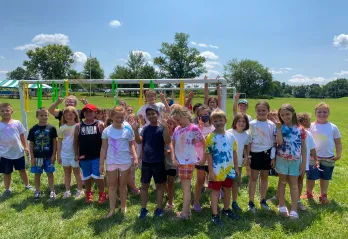 group of 30 children pose for outdoor photo