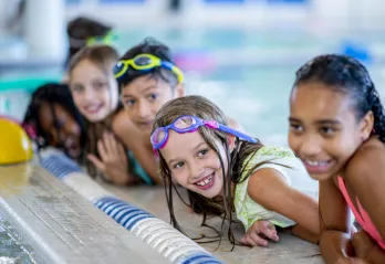 kids smiling in water swim lesson