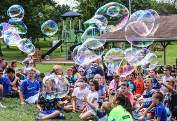campers watch large bubbles