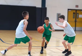 teens playing basketball 