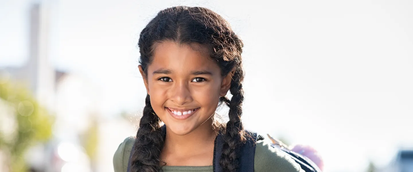 school age girl with backpack