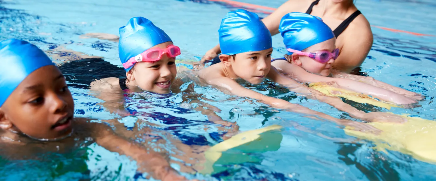 swim instructor with students in water