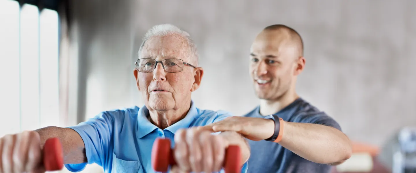 personal trainer with senior client