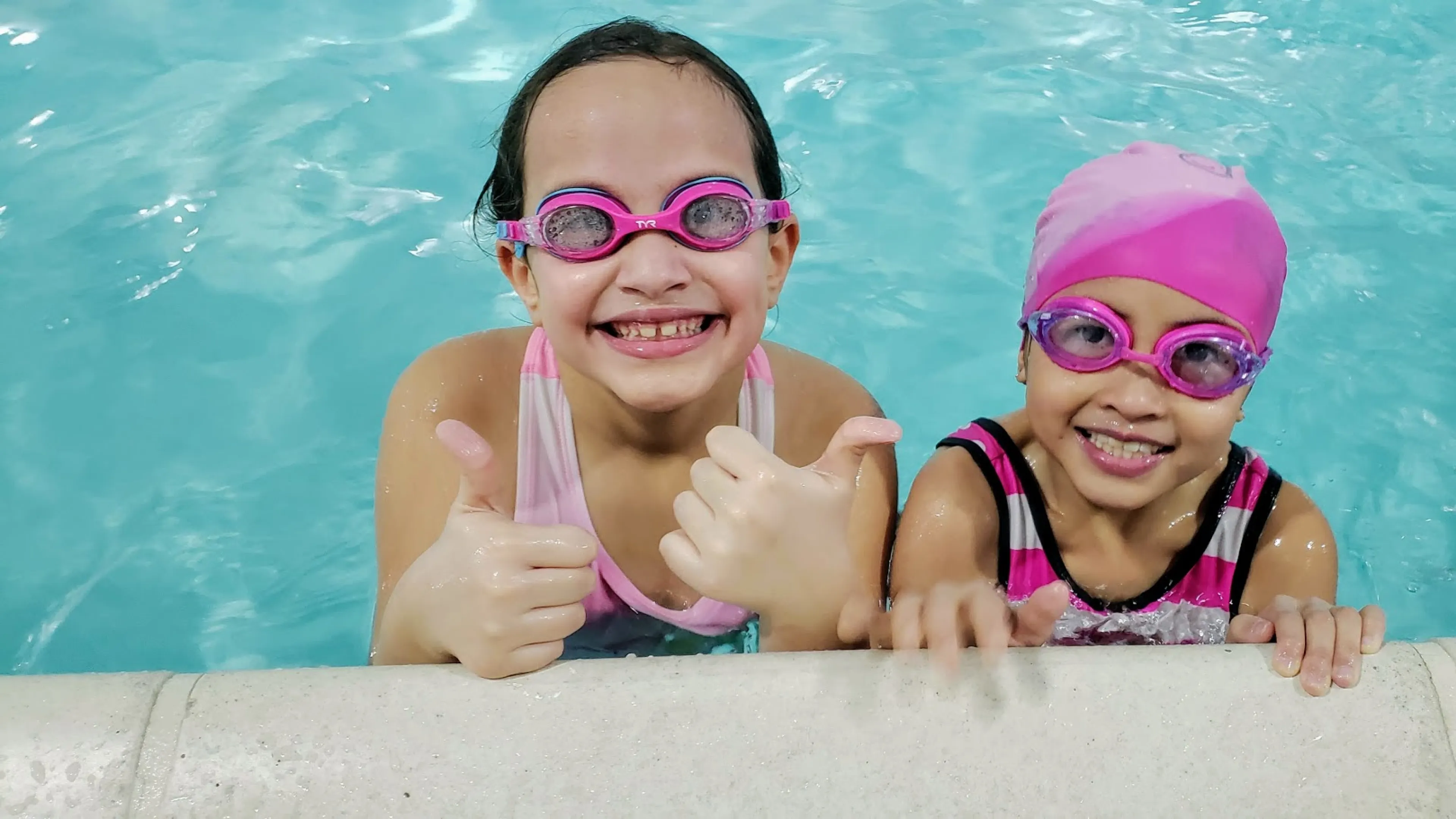 young girls smiling in pool