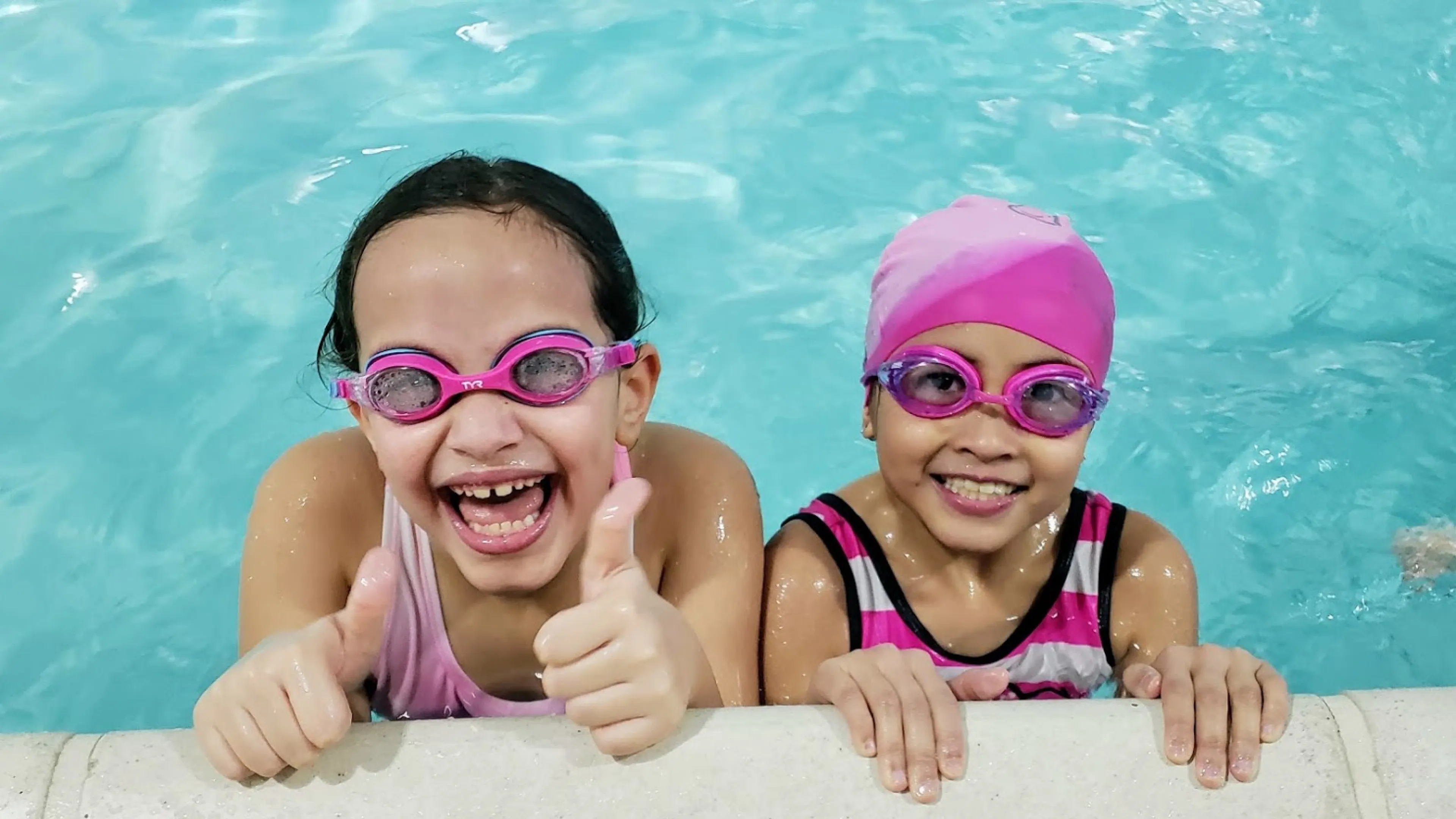 girls smiling in swimming pool