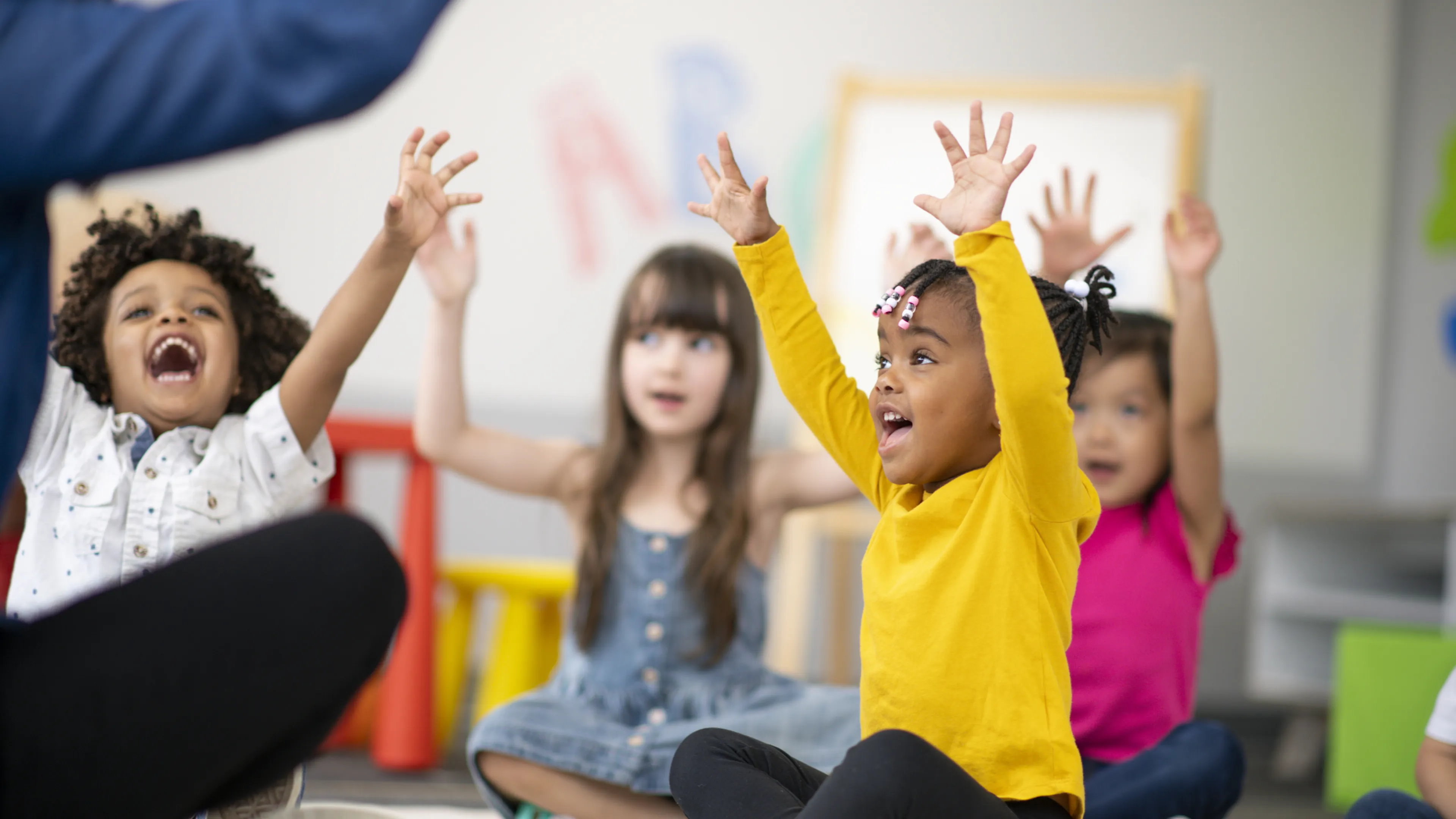 child care children with hands up