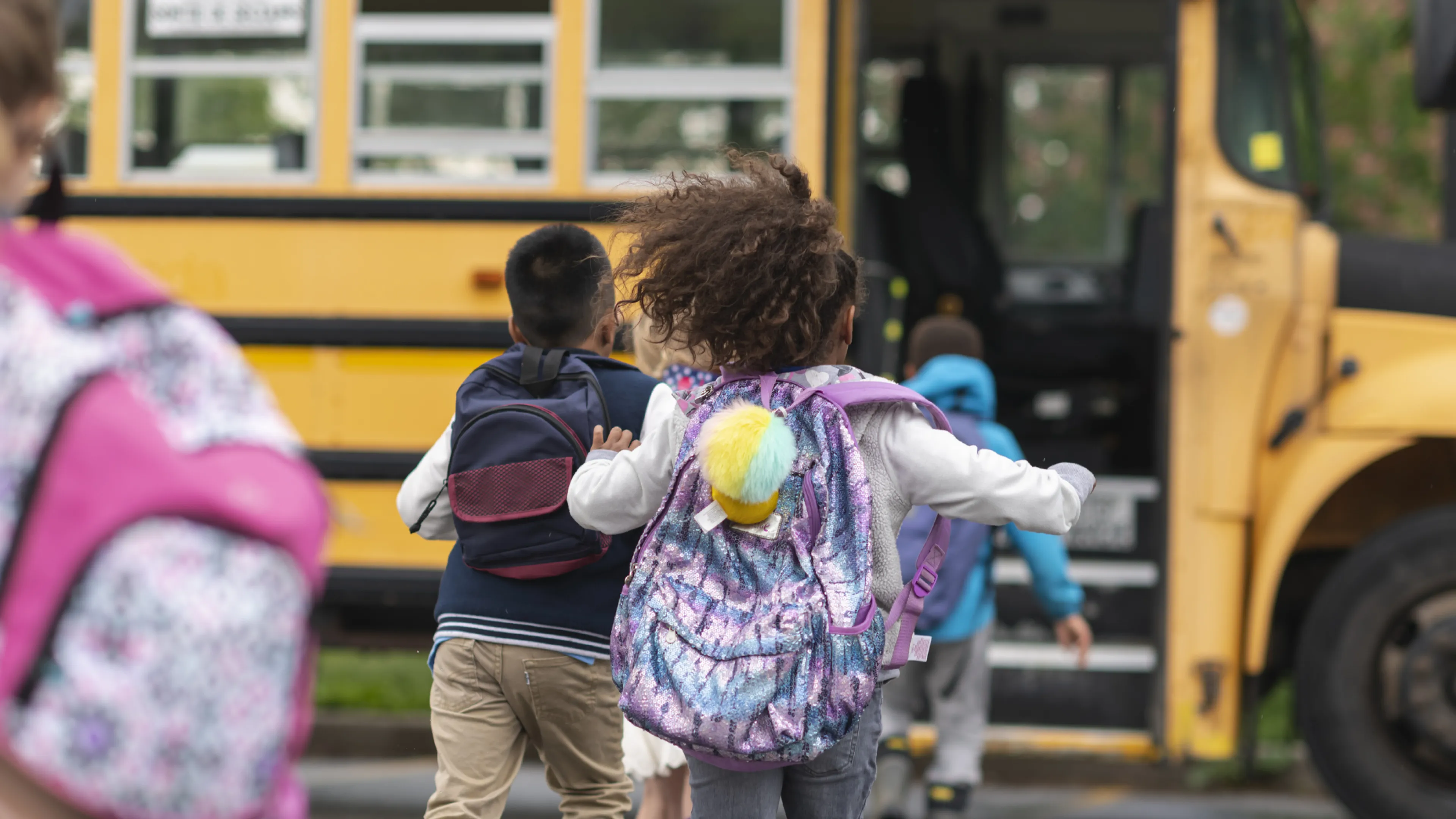 child running to school bus