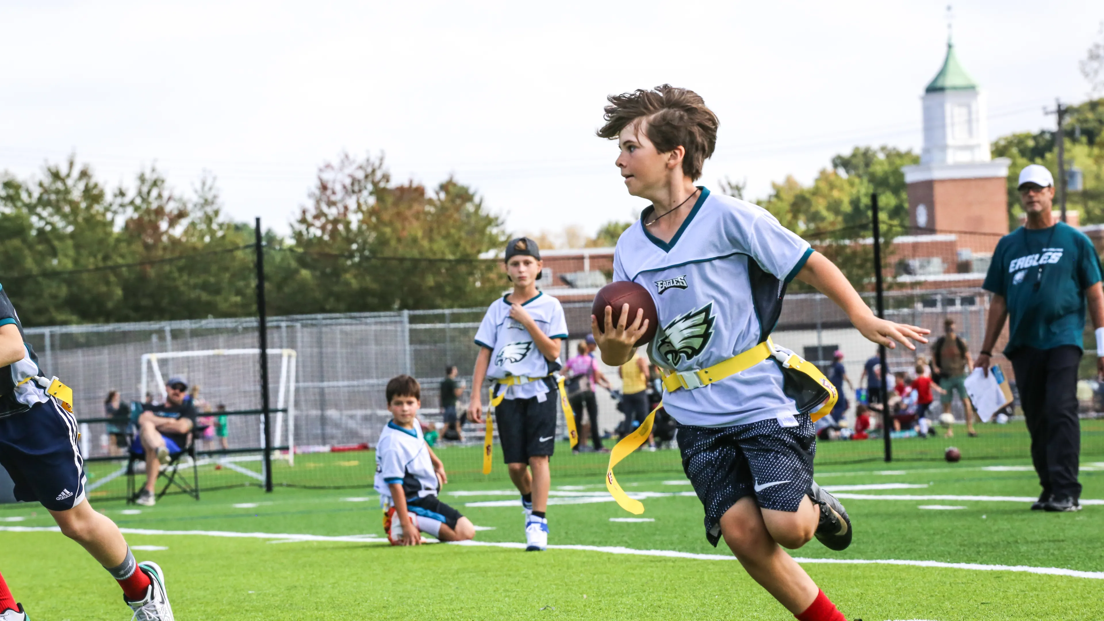 young teen playing flag football