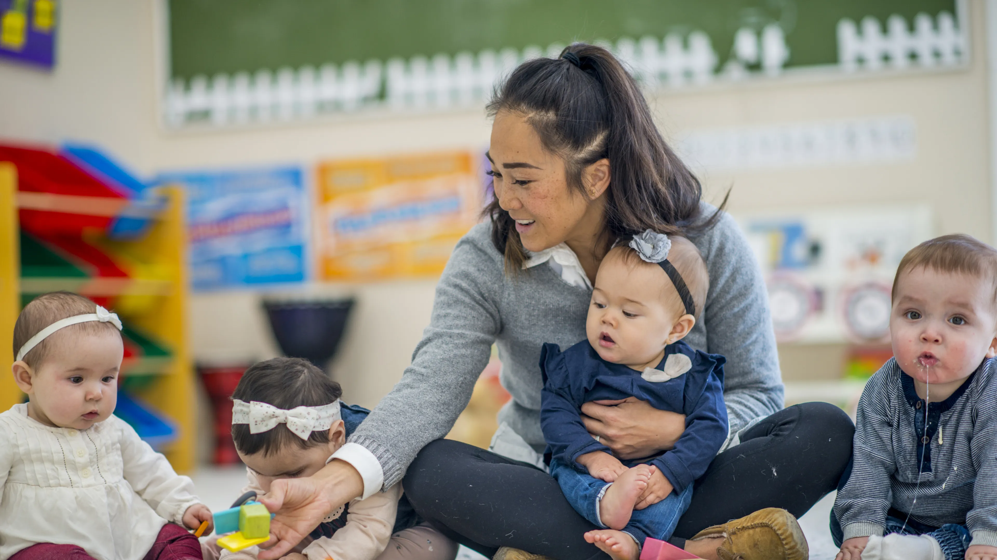 toddlers in classroom with teacher