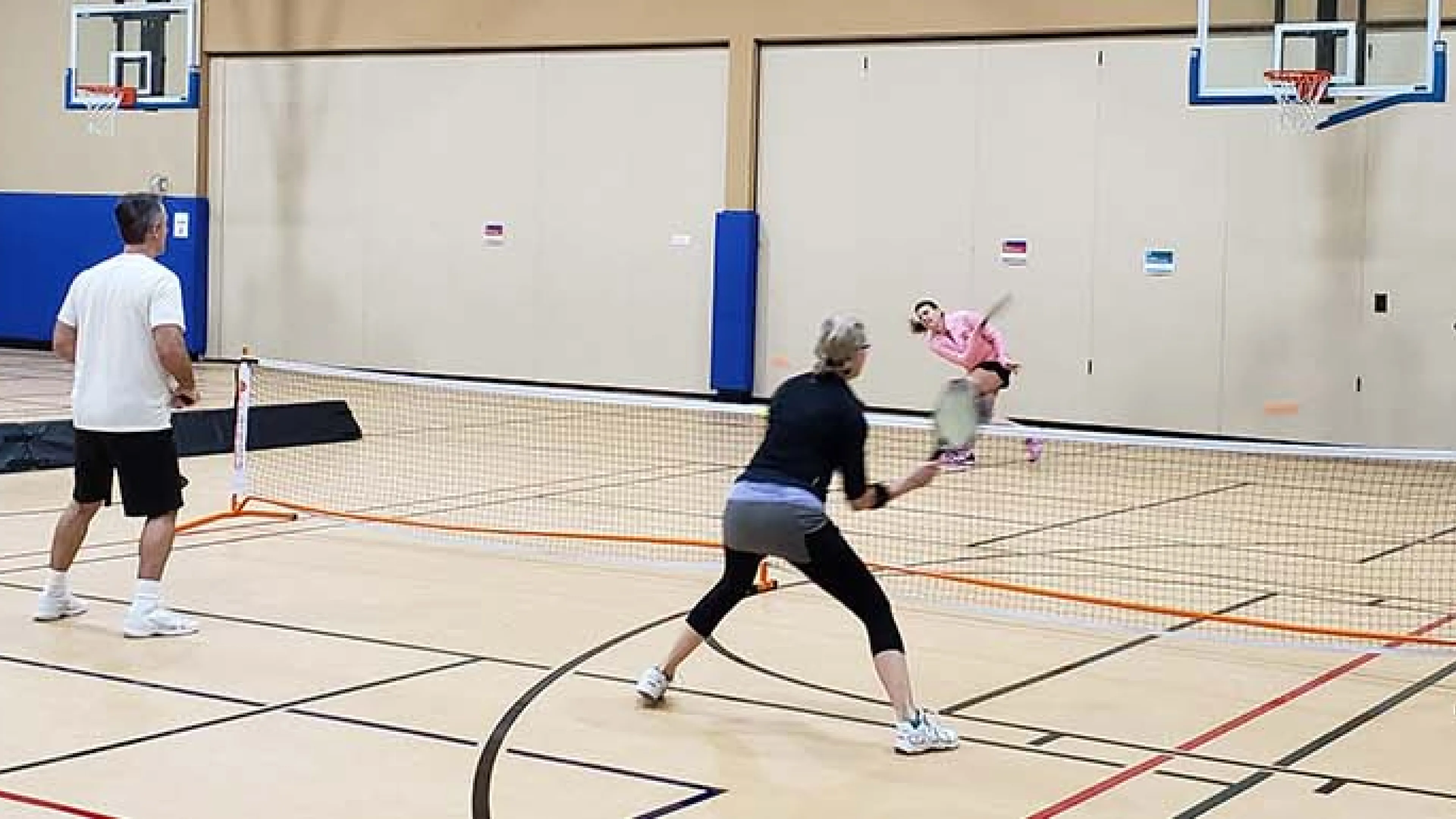 adults playing pickleball