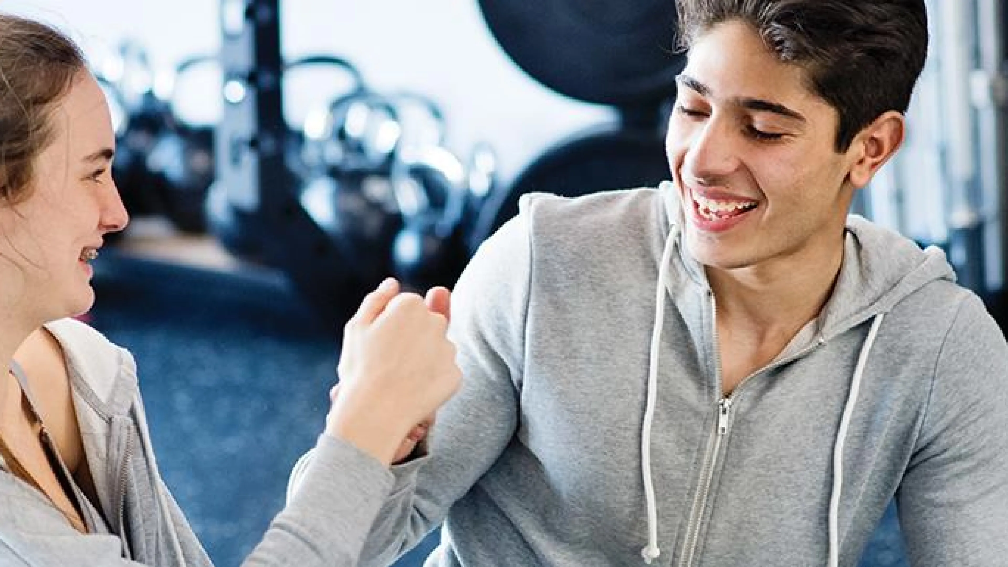 teen fist bump in fitness center