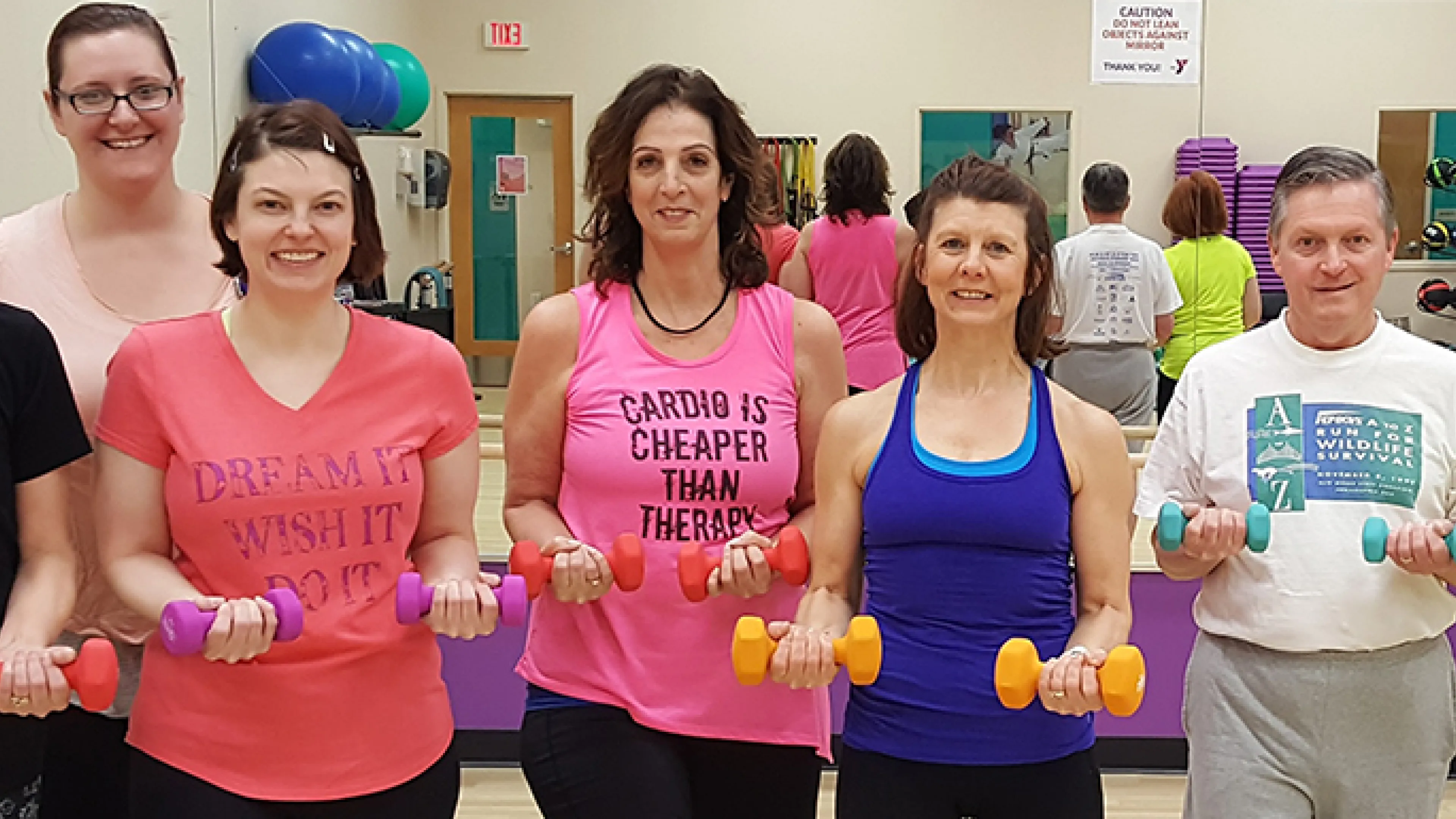 group of adults holding weights