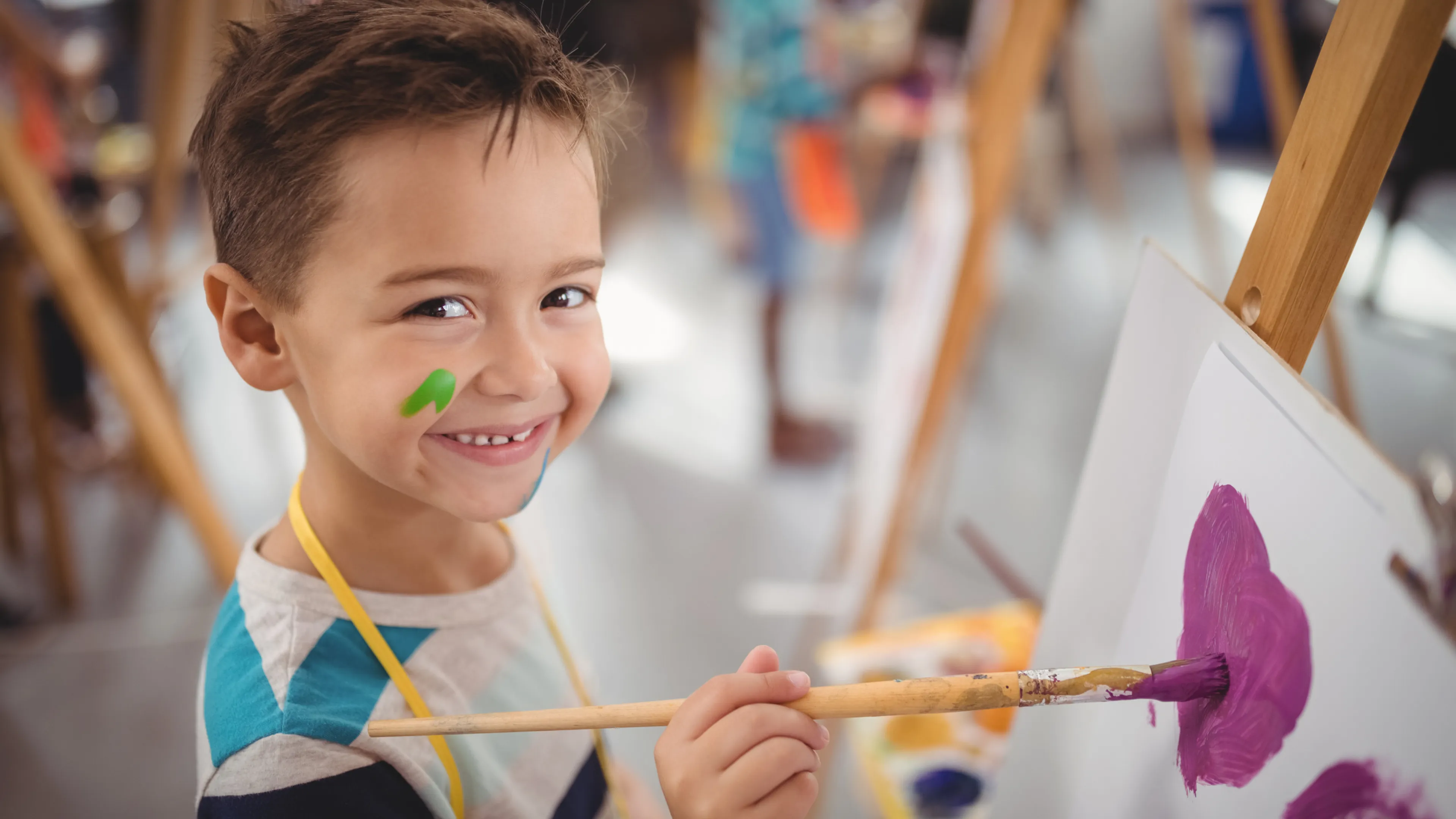 kid painting on canvas