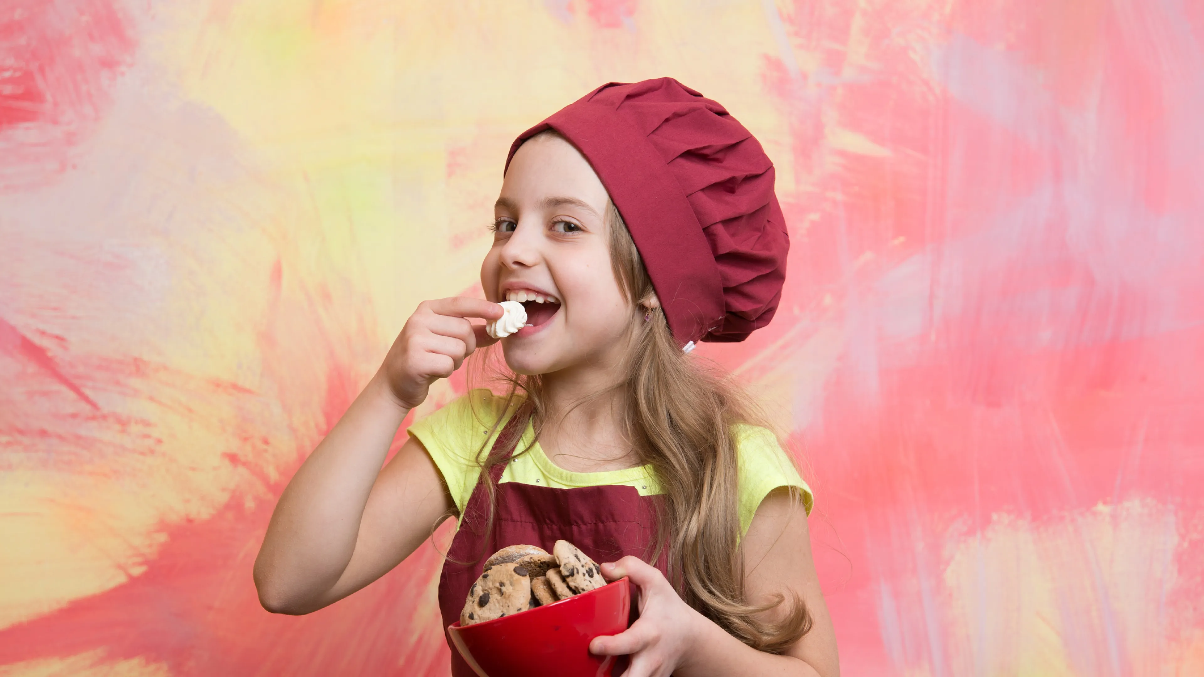 kid holding bowl of cookies