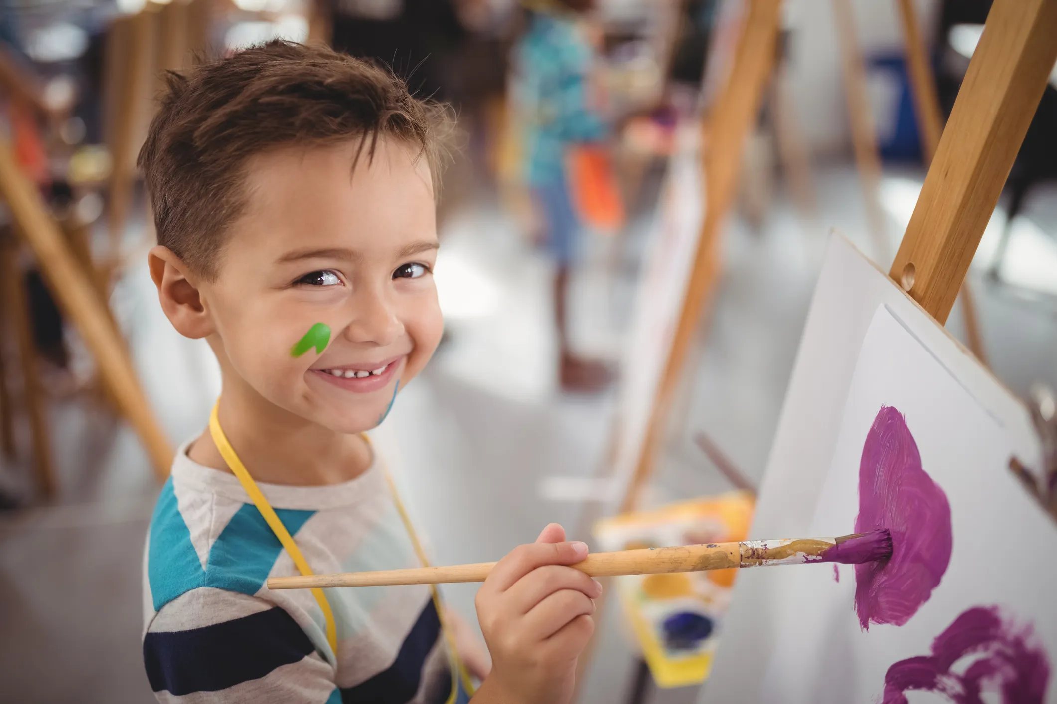kid painting on canvas