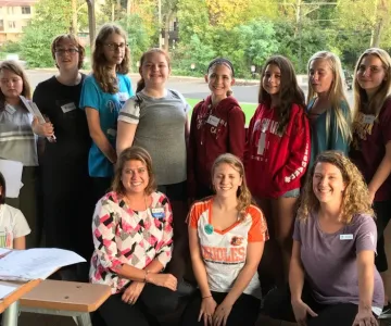 large group of women and teens posing for photo