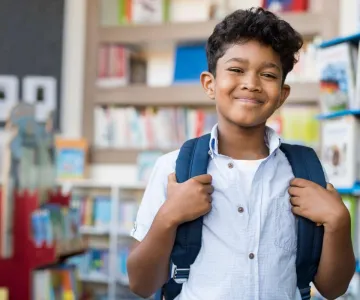 school age boy with backpack