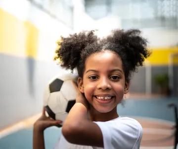 girl holding soccer ball