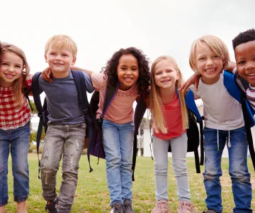 school age children with backpacks