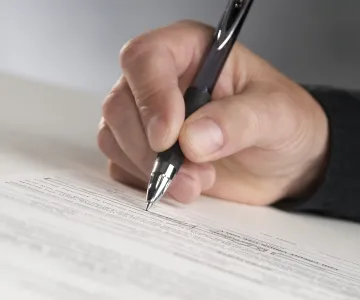 hand signing paper