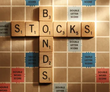 stocks and bonds words on scrabble board