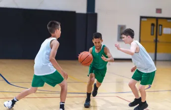 teens playing basketball 