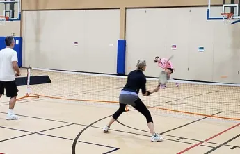 adults playing pickleball