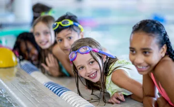 kids smiling in water swim lesson